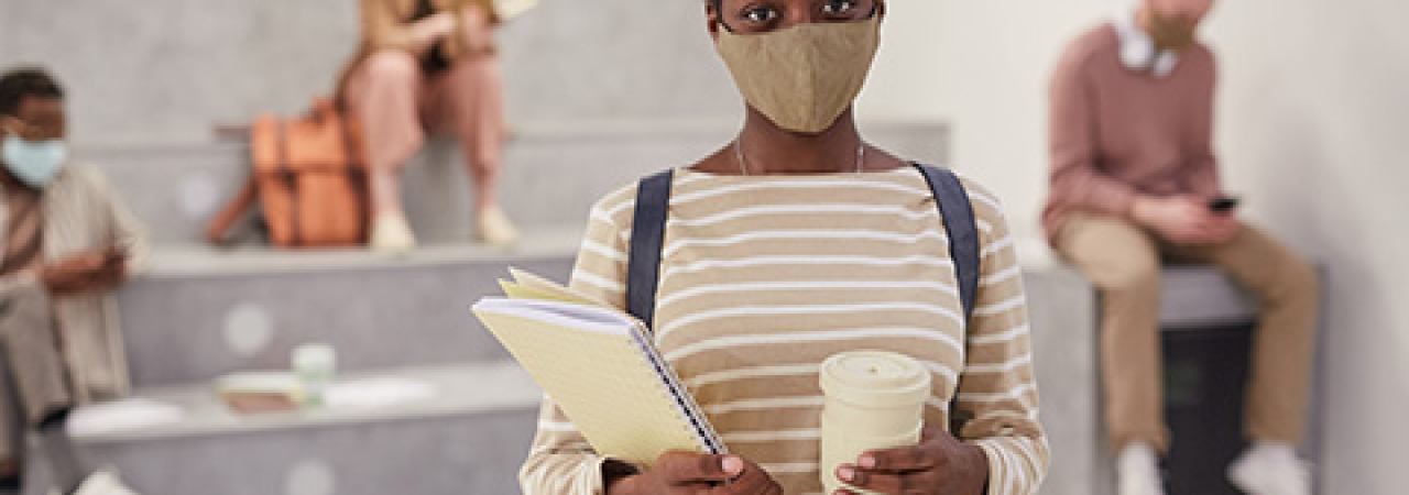 African American woman wearing mask in college
