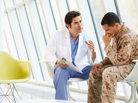 doctor talking to military personnel